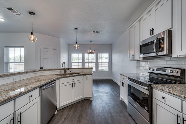 kitchen with white cabinets, a healthy amount of sunlight, sink, and appliances with stainless steel finishes