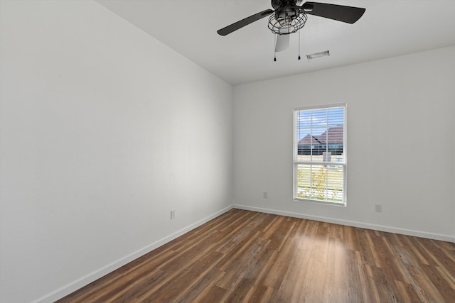 unfurnished room featuring wood finished floors, visible vents, a ceiling fan, and baseboards