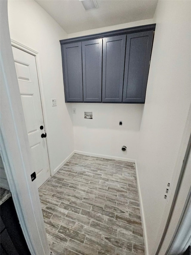 laundry room with hookup for an electric dryer, cabinet space, baseboards, visible vents, and washer hookup