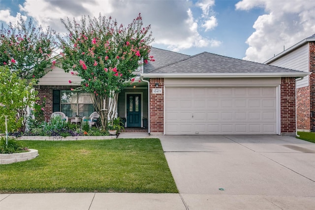 view of front of property featuring a garage and a front lawn