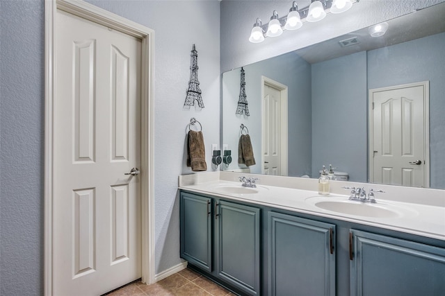 bathroom featuring tile patterned flooring and vanity