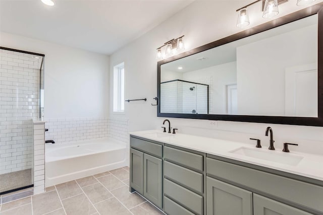 11712 Blackfoot Ct, Godley, TX 76044 - bathroom with a shower stall, a bath, double vanity, tile patterned flooring, and recessed lighting