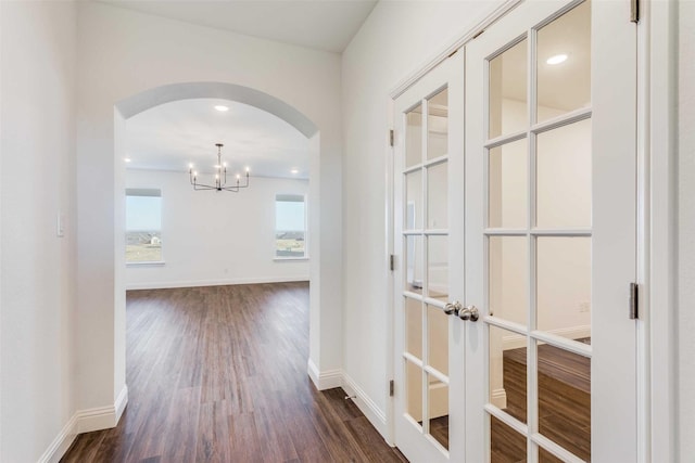 11712 Blackfoot Ct, Godley, TX 76044 - corridor featuring arched walkways, dark wood-style flooring, a chandelier, baseboards, and recessed lighting