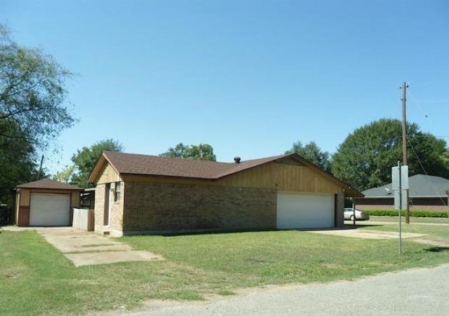 single story home with a front yard and a garage