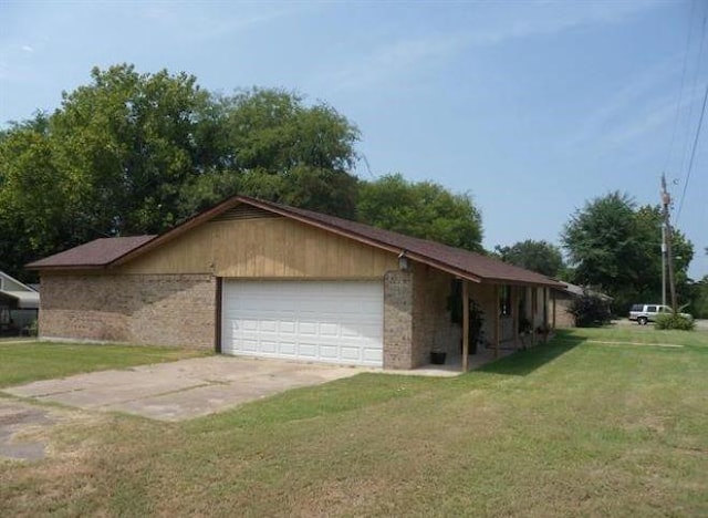 view of property exterior with a garage and a yard