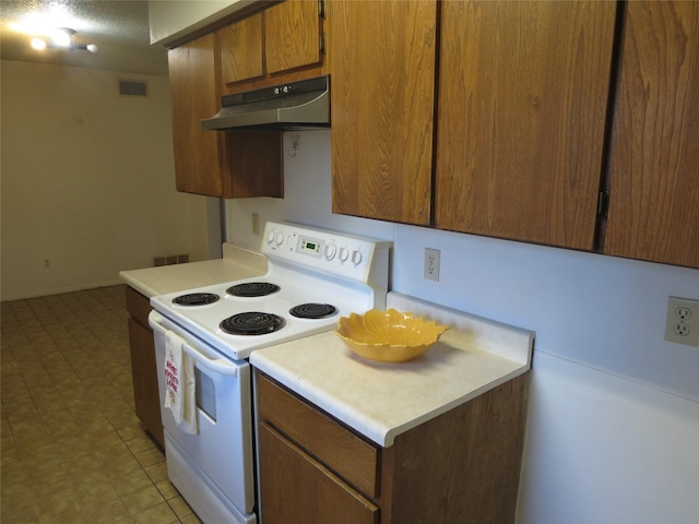 kitchen with electric range and a textured ceiling