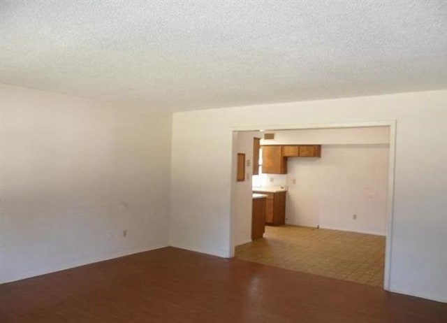 unfurnished room featuring a textured ceiling