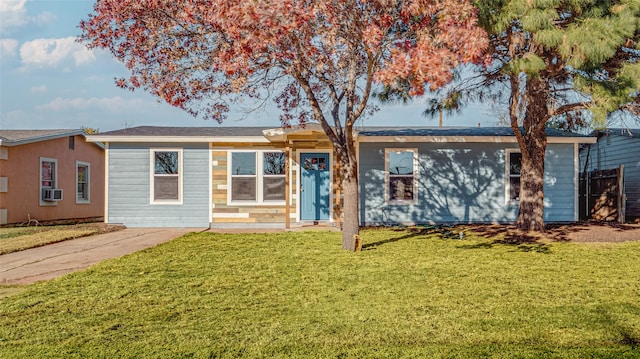 single story home featuring a front lawn and cooling unit