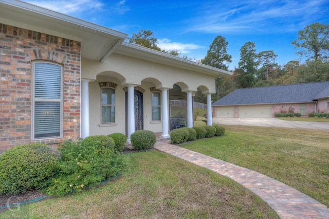 view of front of house with a garage, a porch, and a front yard