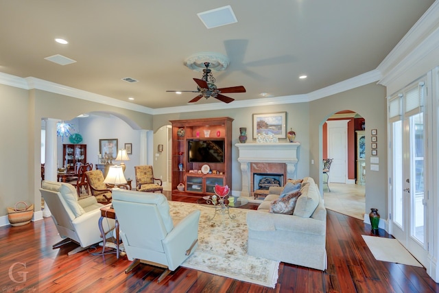 living room featuring dark hardwood / wood-style floors, plenty of natural light, and crown molding