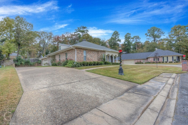 view of front of house featuring a garage and a front lawn