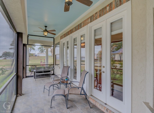 sunroom / solarium featuring ceiling fan