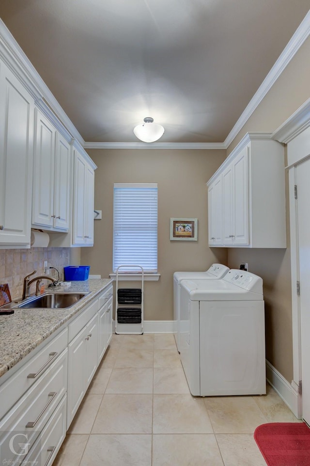 clothes washing area with cabinets, independent washer and dryer, sink, and ornamental molding