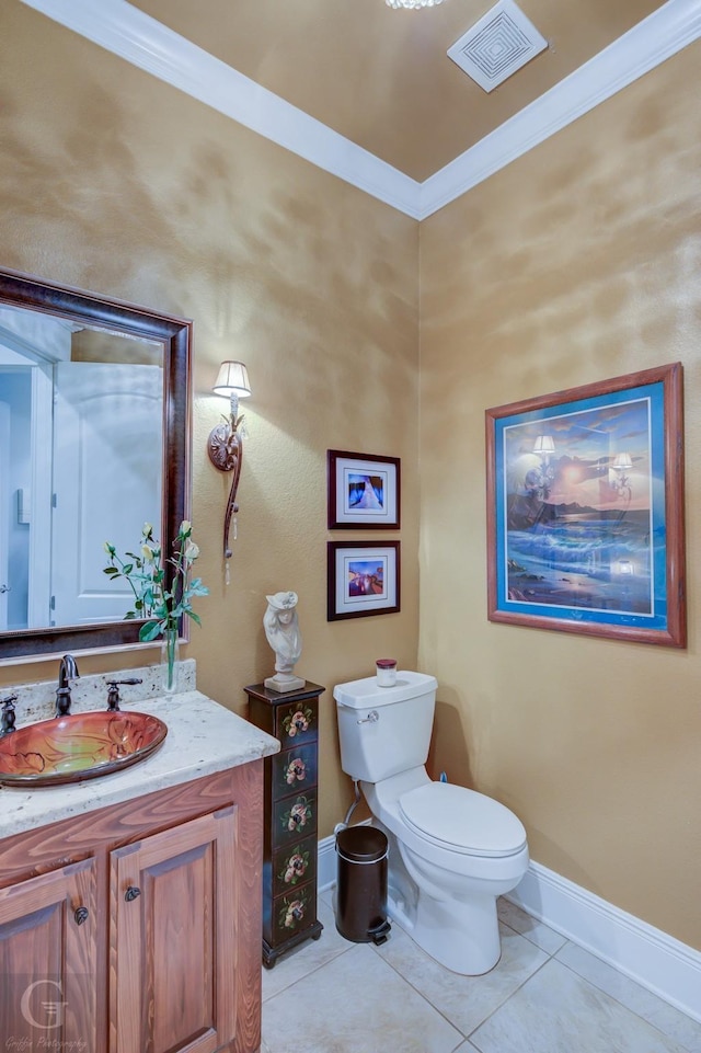 bathroom featuring tile patterned floors, crown molding, vanity, and toilet