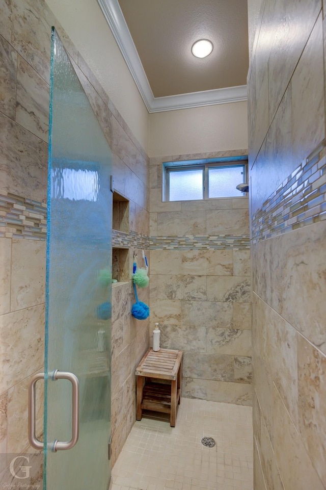 bathroom featuring a shower with door and ornamental molding