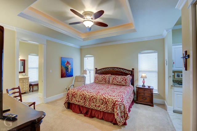 bedroom with light colored carpet, a raised ceiling, multiple windows, and ceiling fan