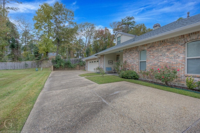 view of front of property featuring a garage and a front lawn