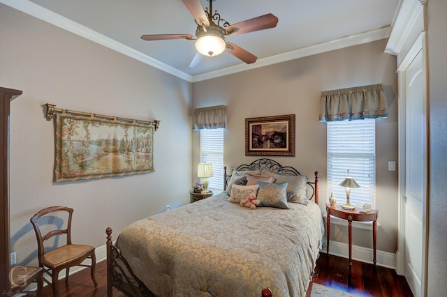 bedroom with ornamental molding, multiple windows, dark wood-type flooring, and ceiling fan