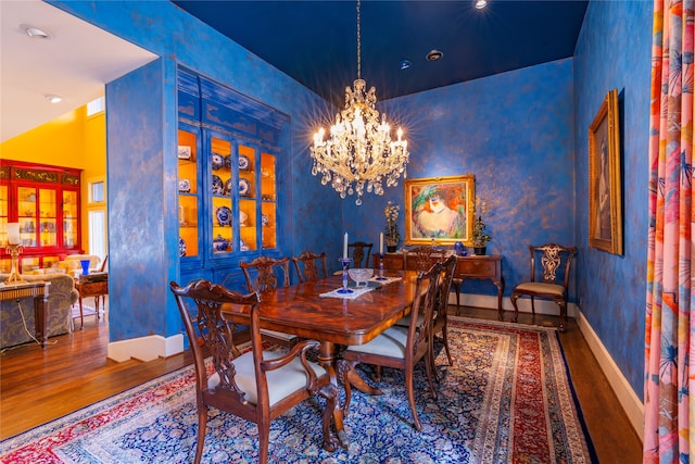 dining room with hardwood / wood-style floors and a chandelier