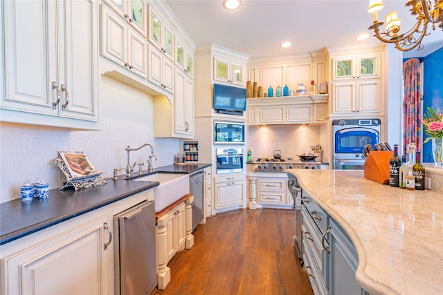 kitchen with white cabinets, dark hardwood / wood-style flooring, hanging light fixtures, and sink