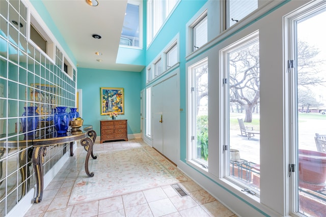 interior space featuring a healthy amount of sunlight and light tile patterned flooring