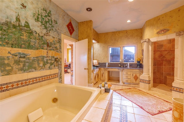 bathroom featuring tile patterned flooring, plus walk in shower, and decorative columns