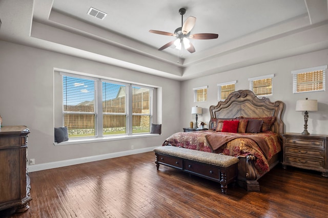 bedroom featuring multiple windows, ceiling fan, and dark hardwood / wood-style flooring