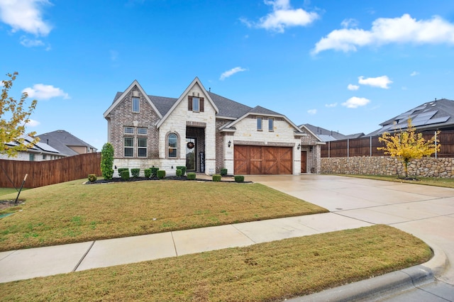 view of front of home with a garage and a front lawn