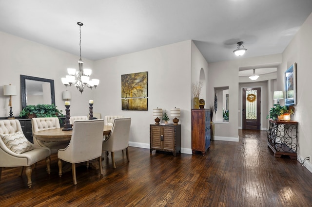 dining room featuring a chandelier and dark wood-type flooring