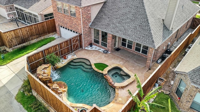 view of swimming pool featuring an in ground hot tub and a patio area