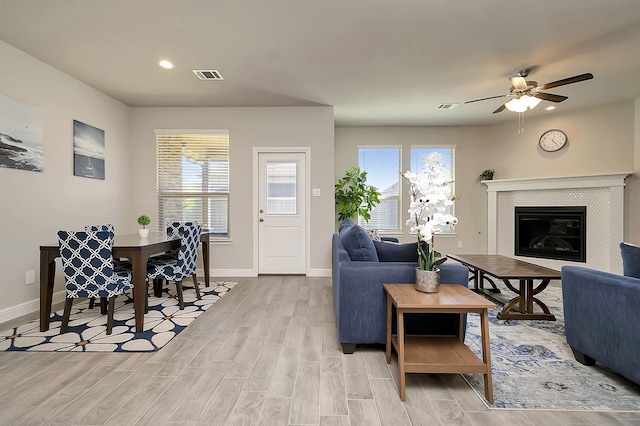 living room with a wealth of natural light, light wood finished floors, and visible vents