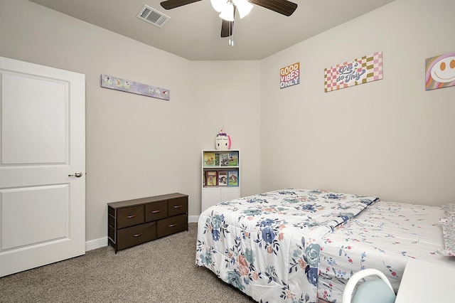 carpeted bedroom featuring a ceiling fan, visible vents, and baseboards