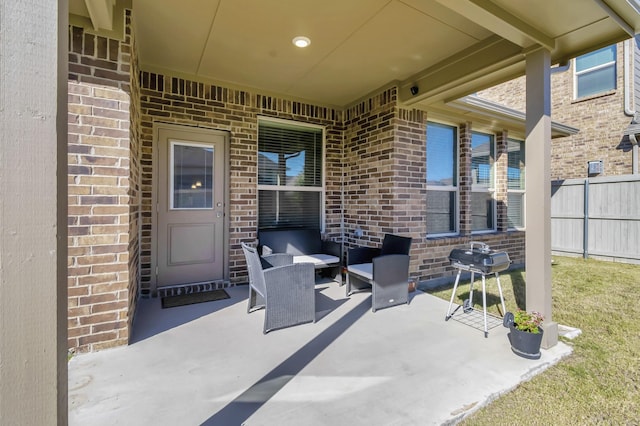 view of patio / terrace with a grill and fence