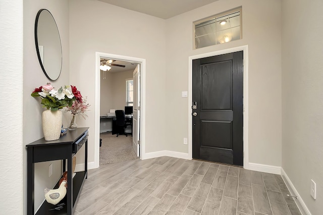 entrance foyer featuring wood tiled floor and baseboards