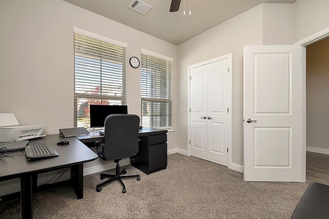 carpeted home office featuring visible vents, ceiling fan, and baseboards