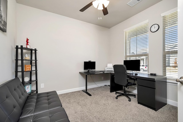 home office with light carpet, ceiling fan, visible vents, and baseboards