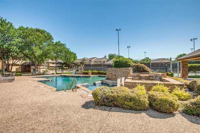 view of pool with a hot tub and a patio