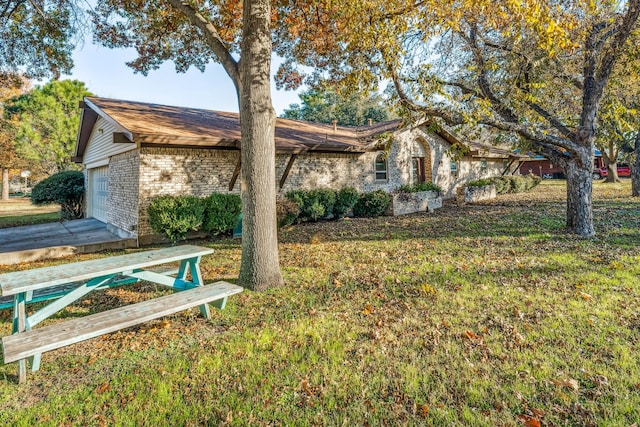 exterior space featuring a garage and a front yard