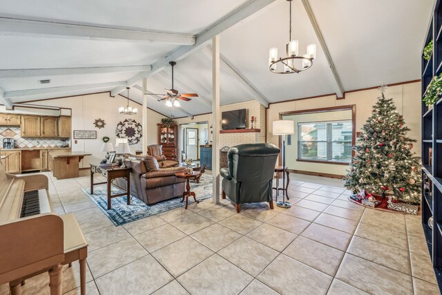 tiled living room with ceiling fan with notable chandelier, lofted ceiling with beams, and a fireplace