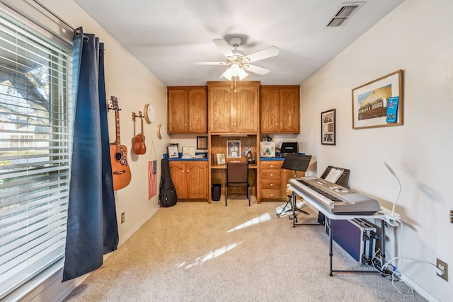 office featuring ceiling fan, plenty of natural light, and light colored carpet