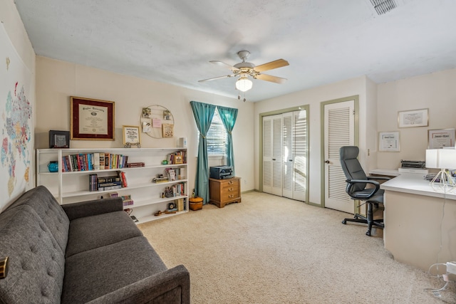 office area with ceiling fan and light colored carpet