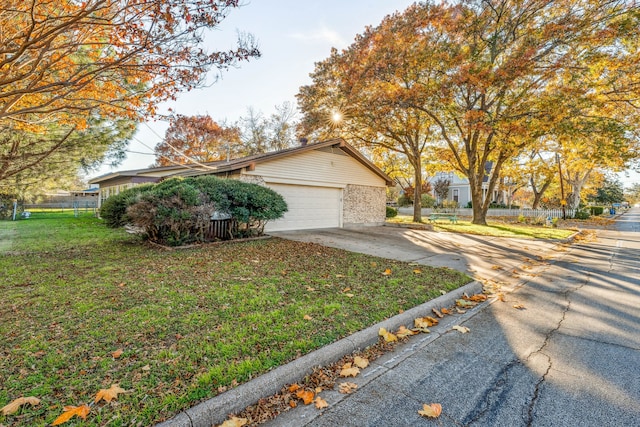 view of property exterior with a garage and a lawn