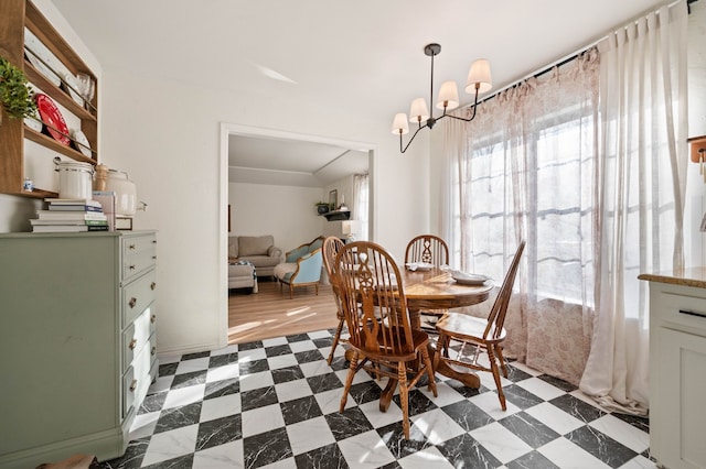 dining room featuring dark floors and a chandelier