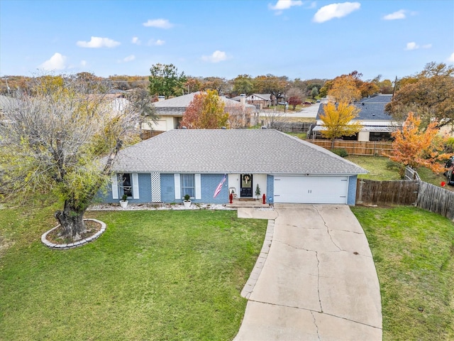 ranch-style house with an attached garage, a shingled roof, fence, concrete driveway, and a front yard