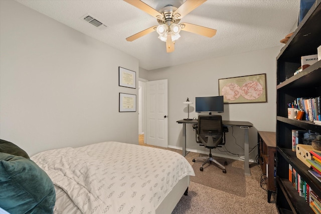 carpeted bedroom featuring visible vents, ceiling fan, a textured ceiling, and baseboards