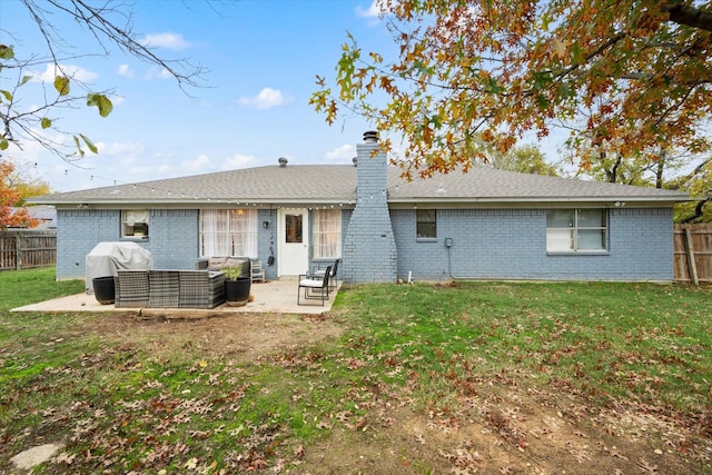 back of property featuring brick siding, a yard, an outdoor hangout area, a patio area, and fence private yard