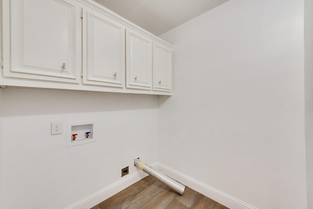 laundry room with hardwood / wood-style floors, hookup for an electric dryer, cabinets, and hookup for a washing machine