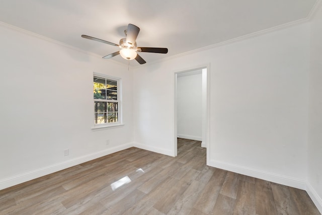 empty room featuring crown molding, ceiling fan, and light hardwood / wood-style floors