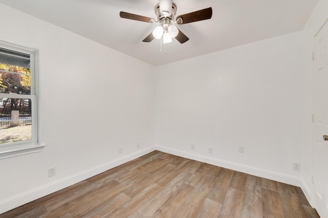 empty room with light wood-type flooring and ceiling fan