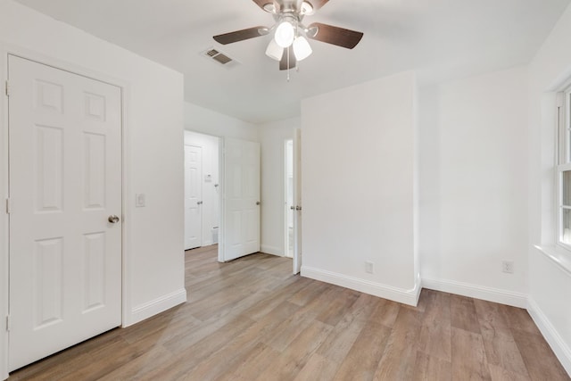 unfurnished bedroom with ceiling fan and light wood-type flooring